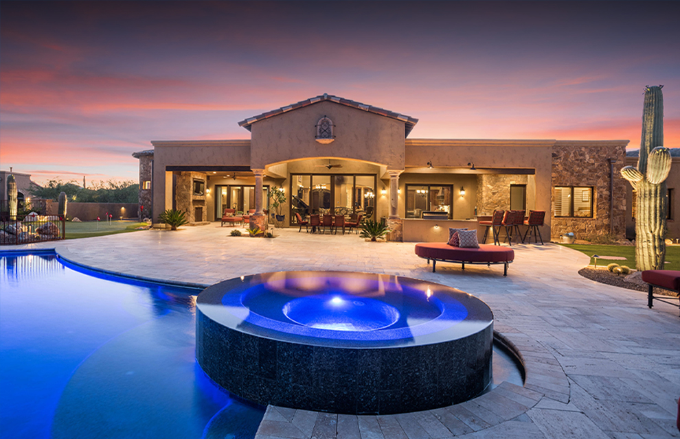 glowing granite pool outside custom desert house by sanctuary custom construction