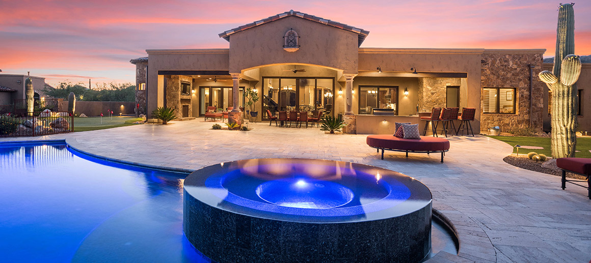 glowing granite pool outside custom desert house by sanctuary custom construction