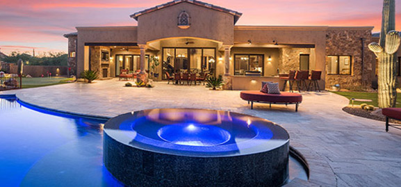 glowing granite pool outside custom desert house by sanctuary custom construction