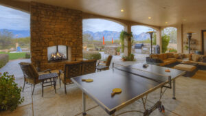 outdoor area with sitting, fireplace, and game for a custom home design for multigenerational living